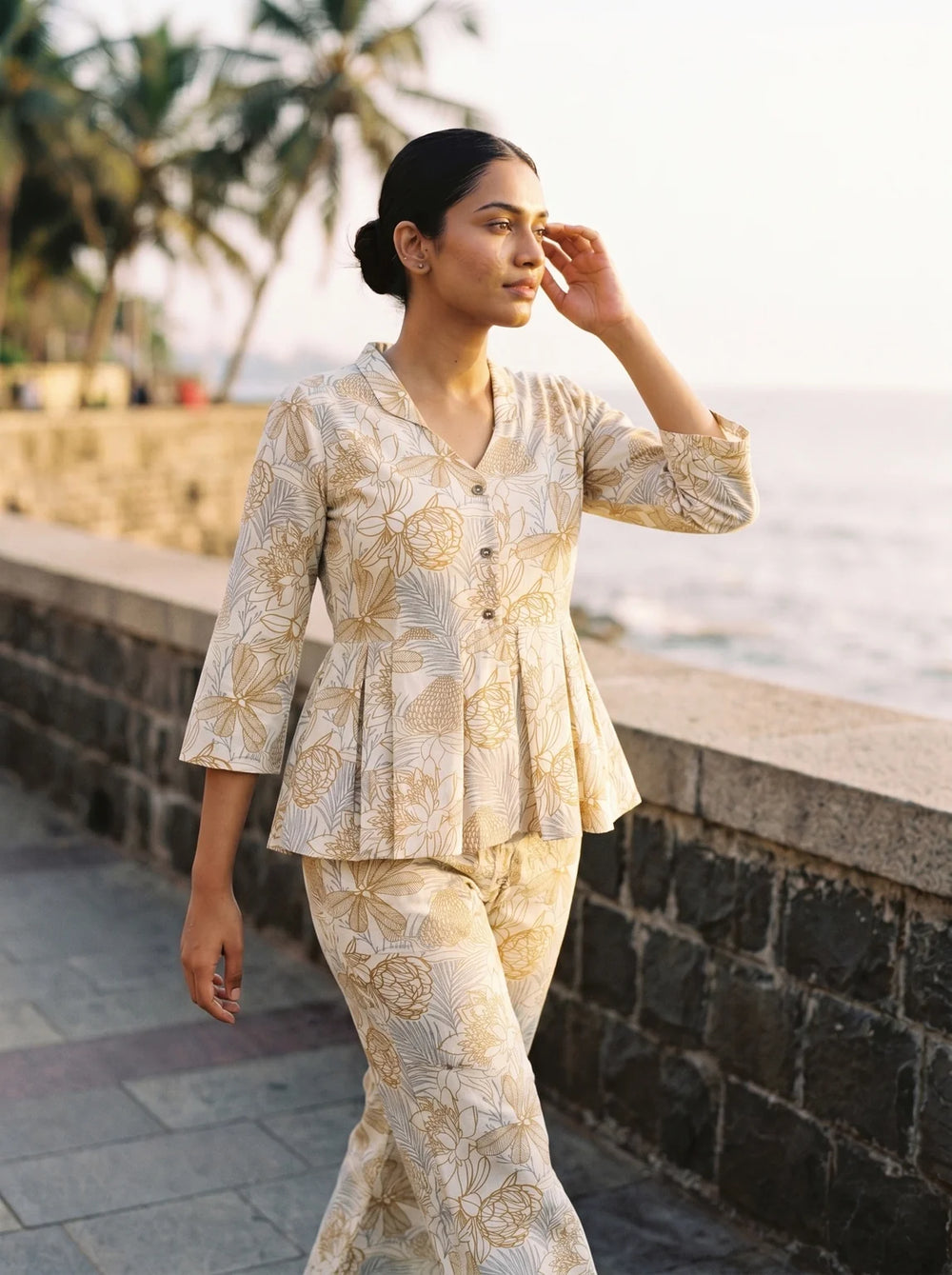 woman in chikoo floral co ord set in a heritage doorway
