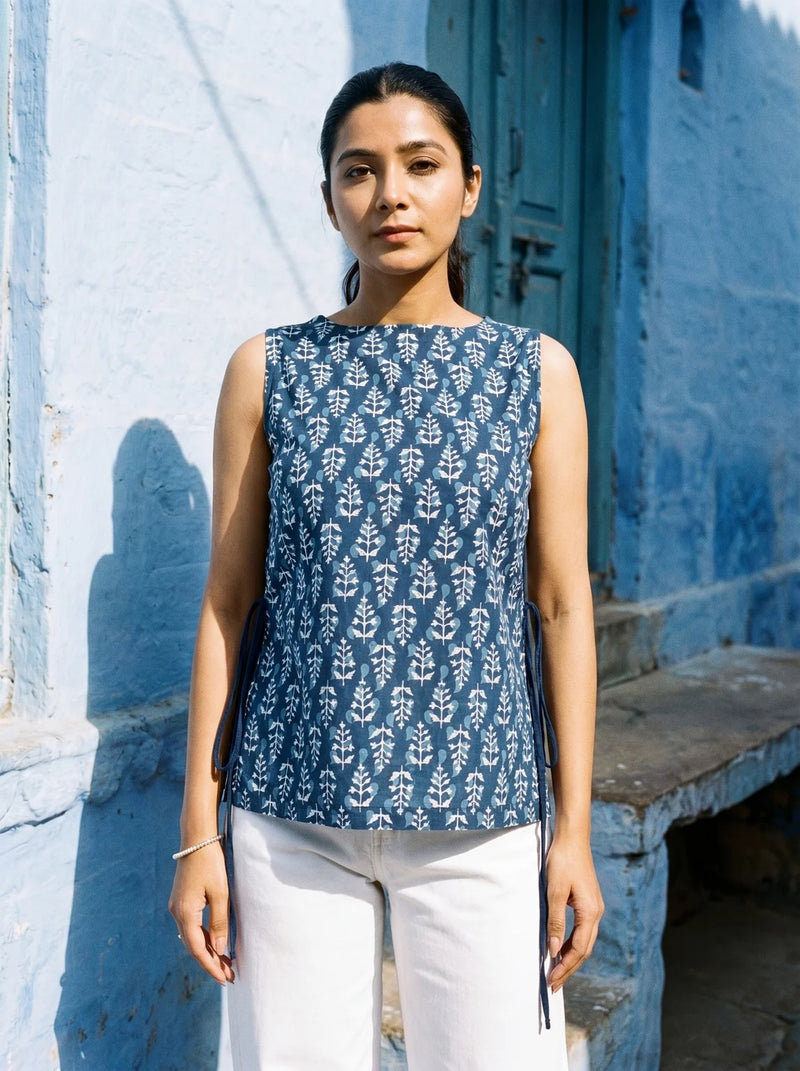 woman in indigo botanical kurti at a blue heritage doorway
