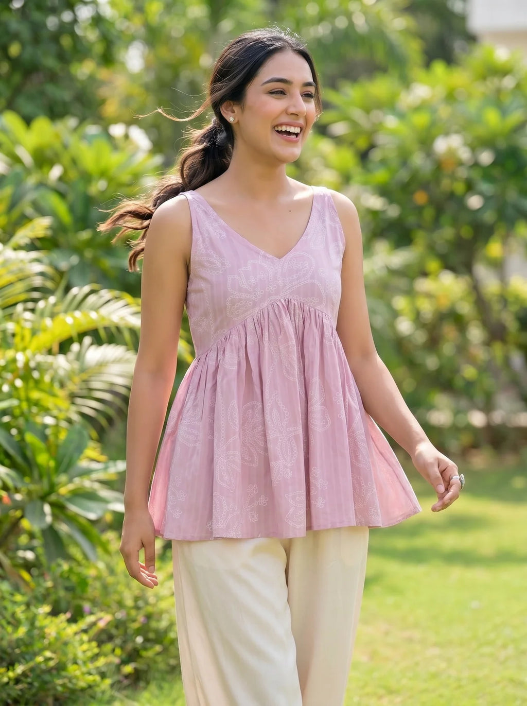 model in baby pink schiffli top lifestyle two