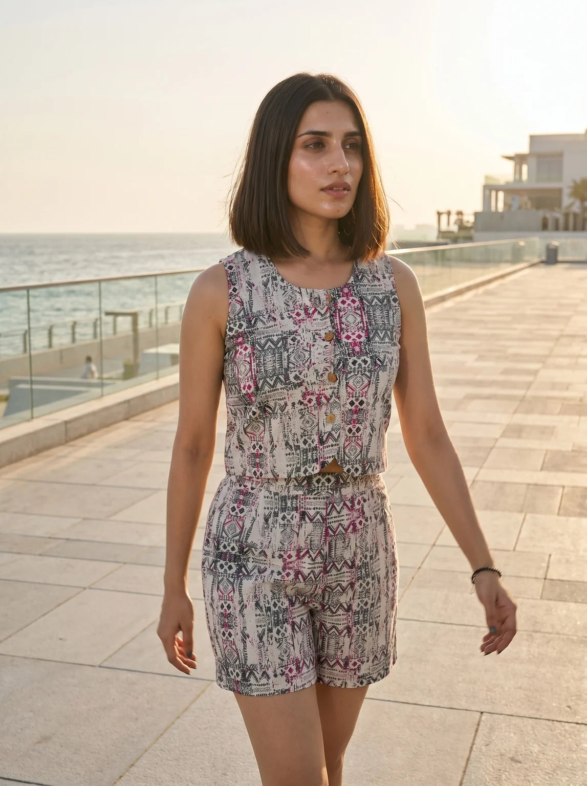 model in printed co-ord set walking seaside golden hour