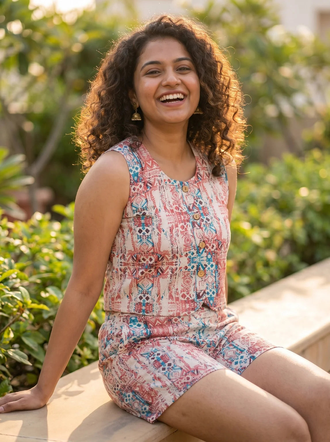 model in red and blue printed co-ord set sunlit terrace