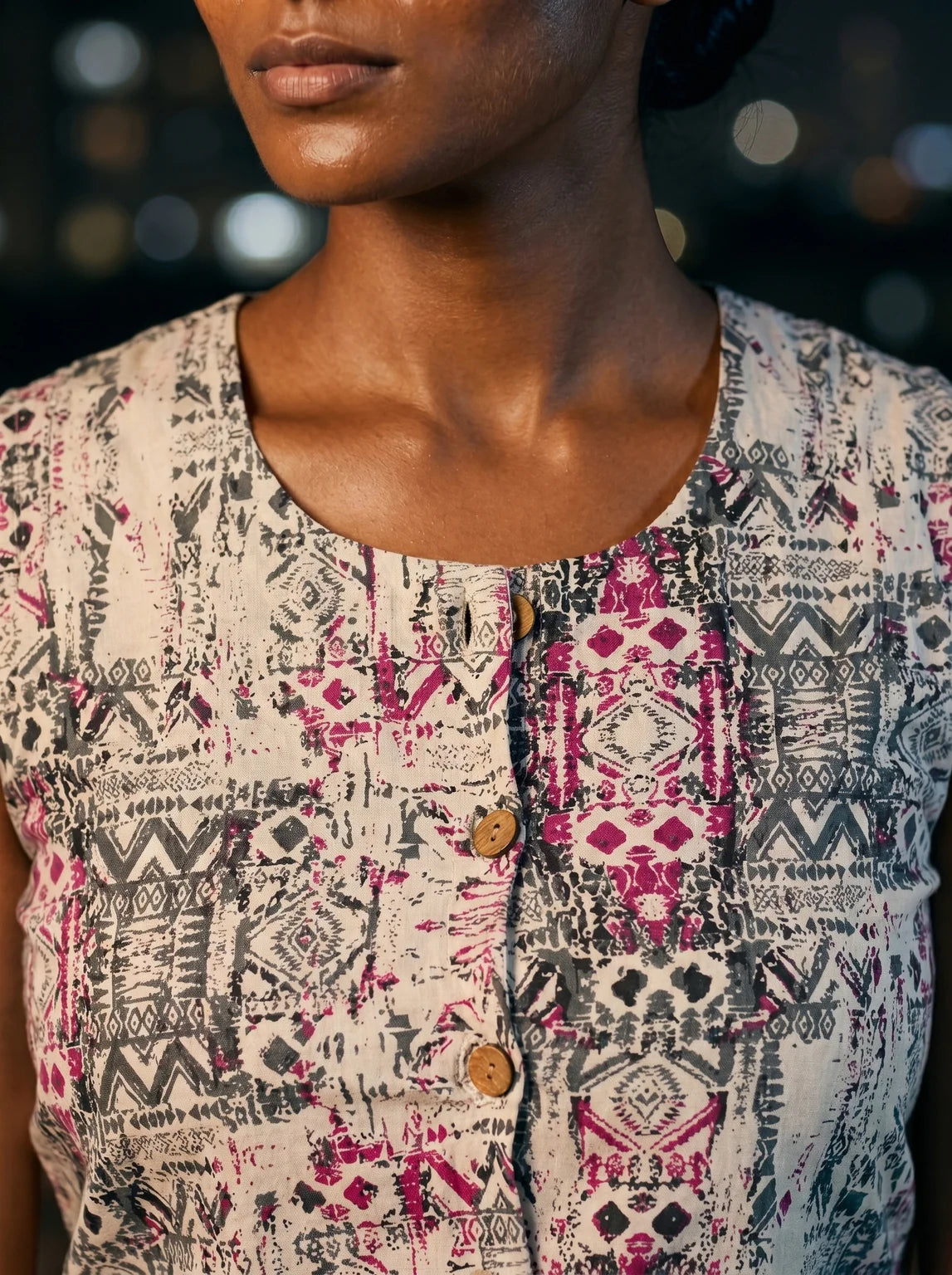 round neck wooden button placket and geometric print closeup