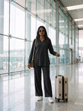 woman in black solid viscose co ord set by a shutter