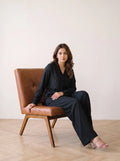 woman in black solid viscose co ord set in a market lane