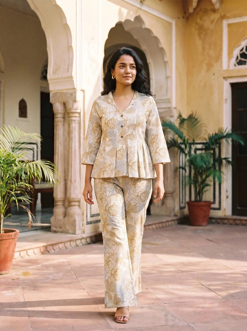 woman in chikoo floral co ord set by a carved door