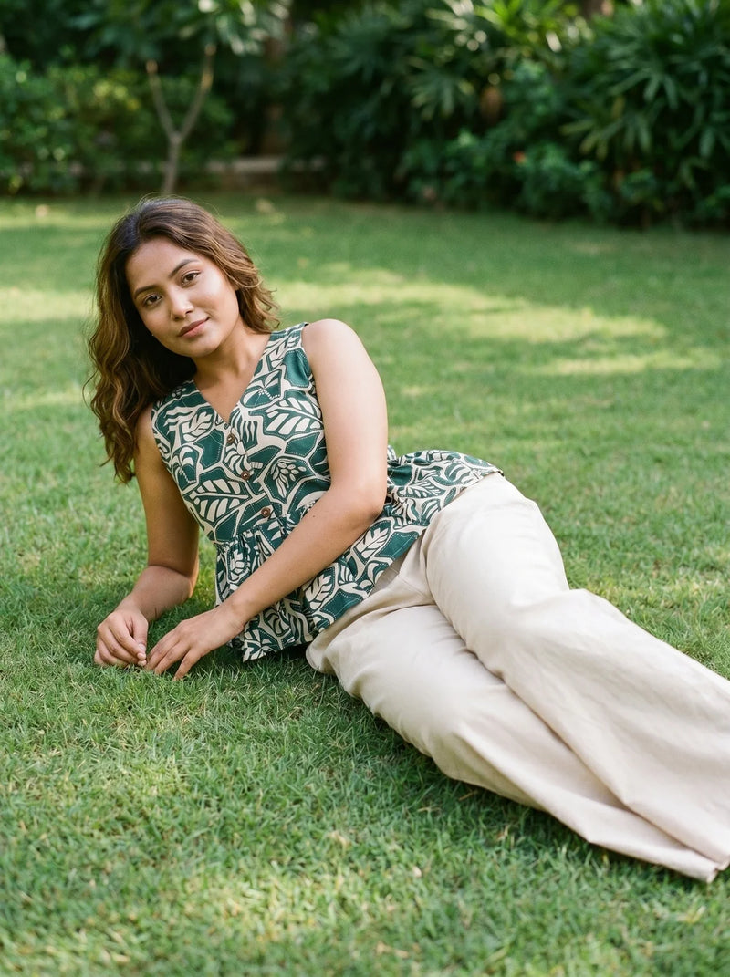 woman in green botanical peplum co ord set poolside evening