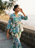 woman in green floral peplum co ord set in a heritage doorway