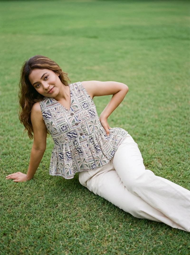 woman in grey tropical peplum co ord set poolside evening