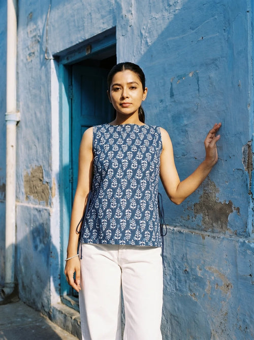 woman in indigo botanical kurti by a blue city wall
