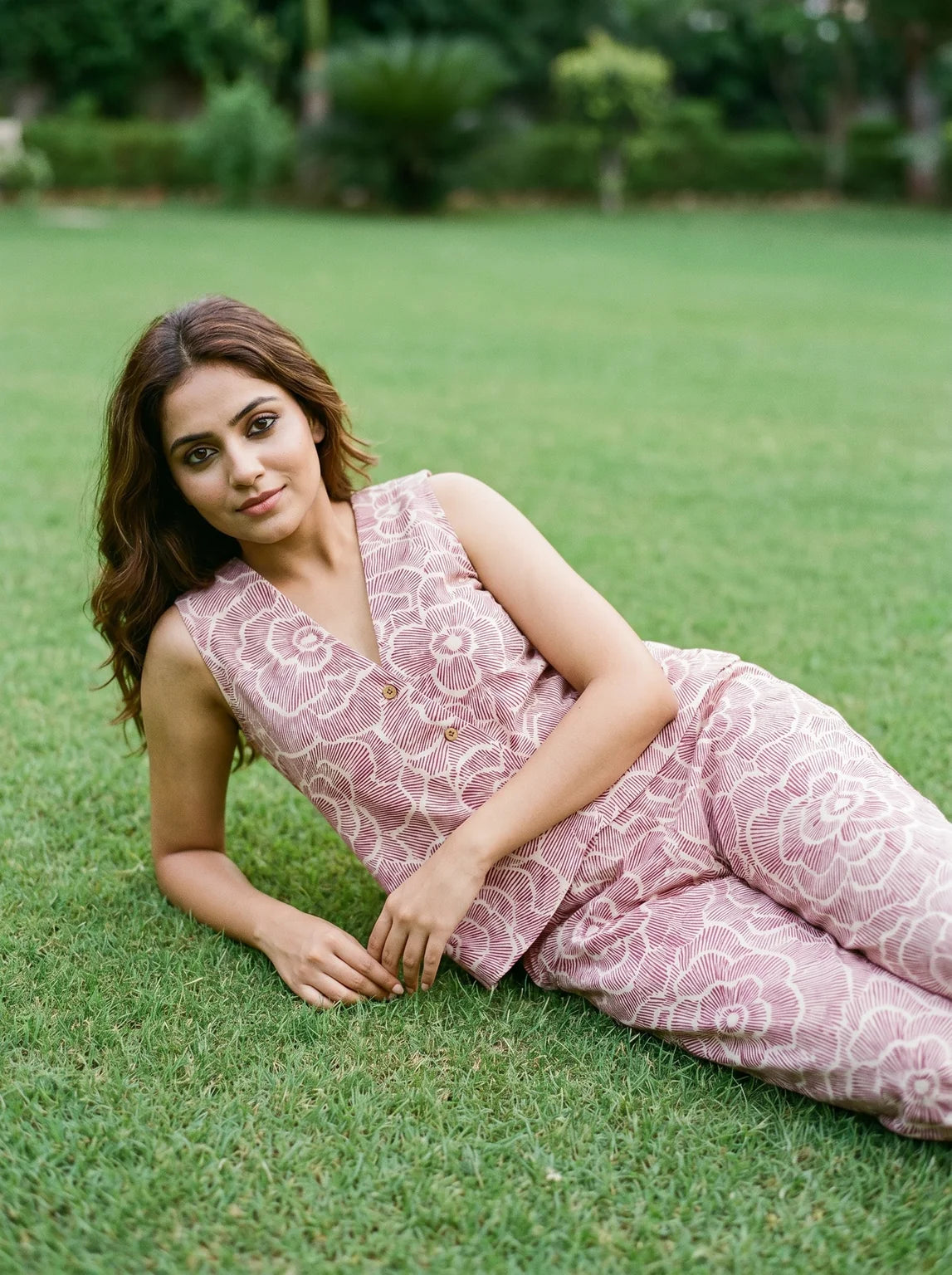 woman in maroon floral co ord set poolside evening