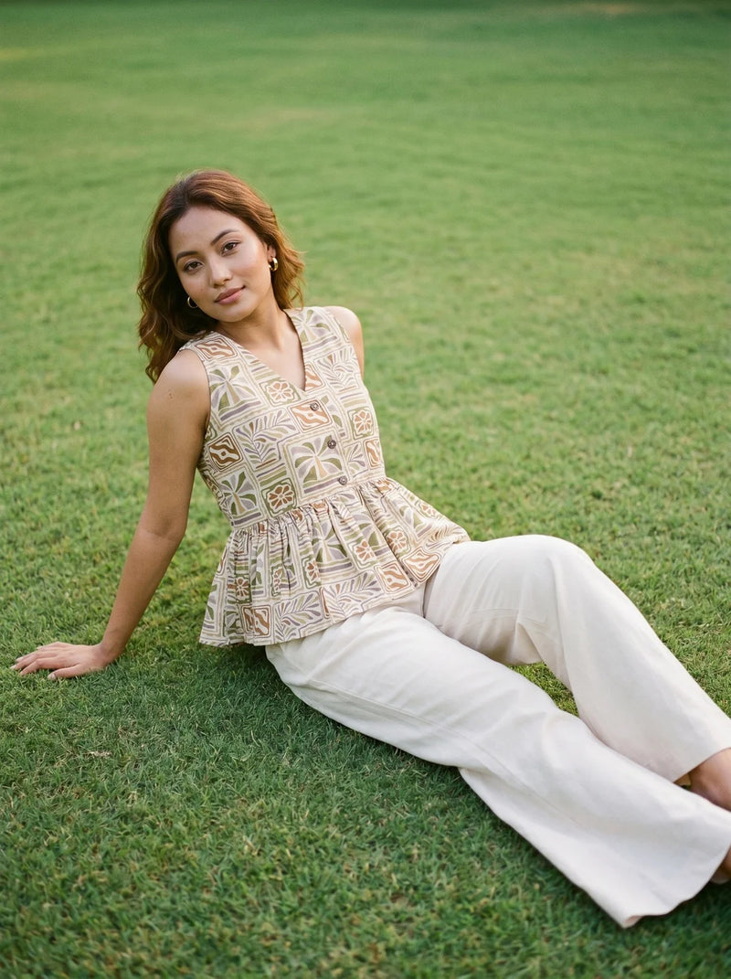 woman in mustard tropical peplum co ord set poolside evening