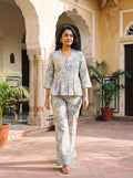woman in rama floral co ord set by a carved door