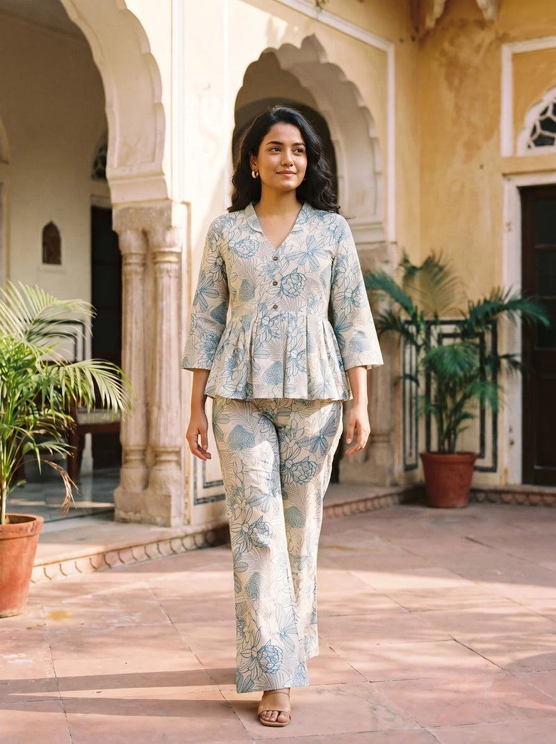 woman in rama floral co ord set by a carved door