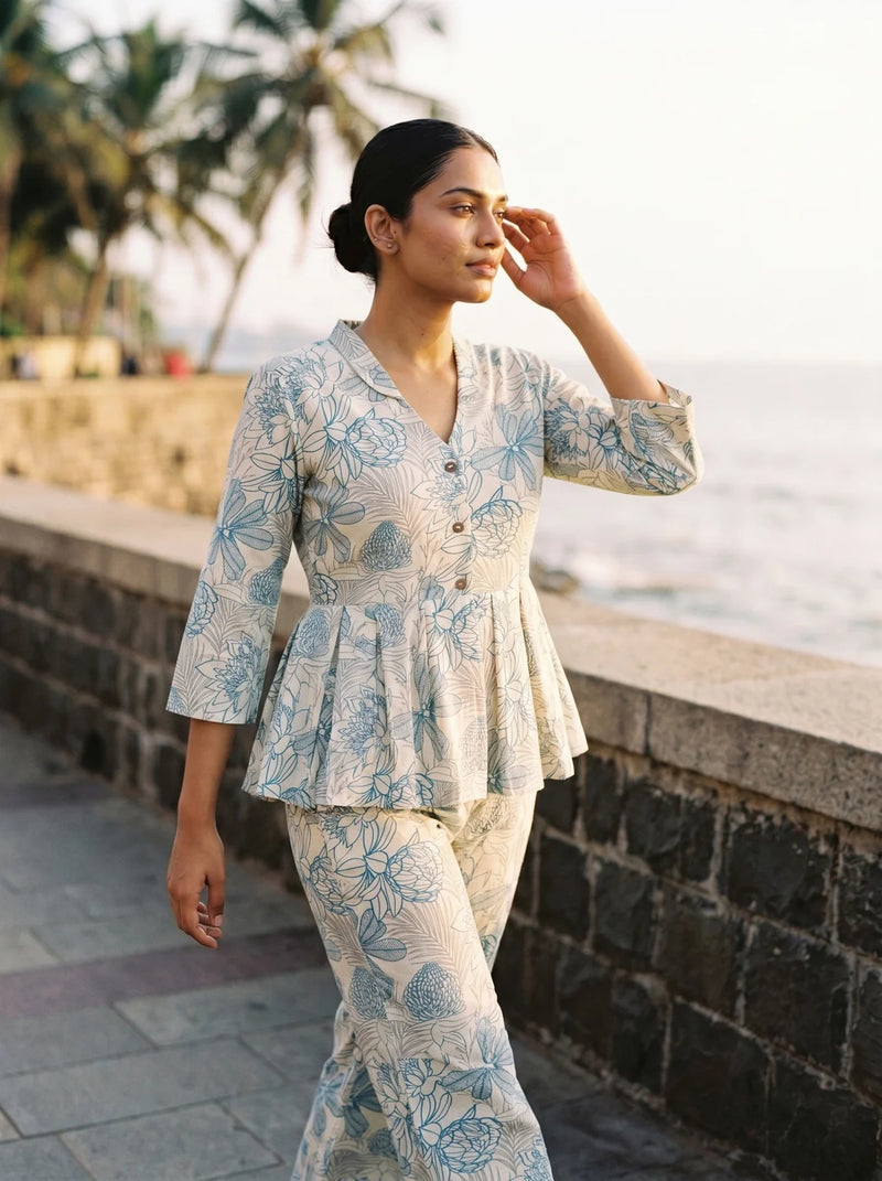 woman in rama floral co ord set in a heritage doorway