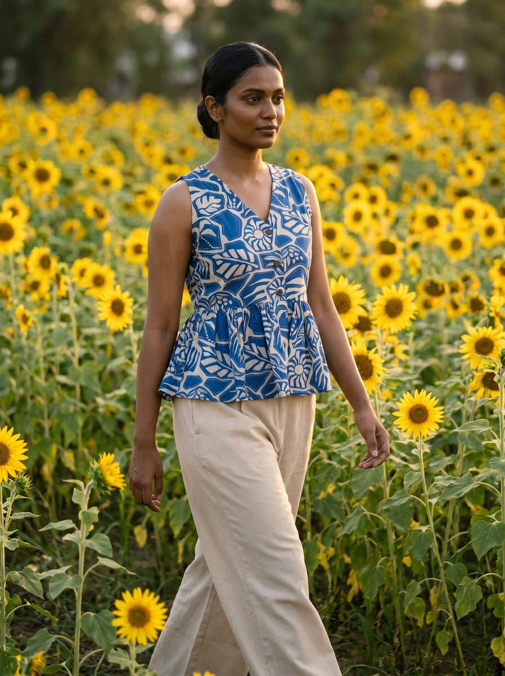 woman in royal blue botanical peplum co ord set by the pool
