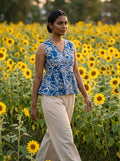 woman in royal blue botanical peplum co ord set by the pool