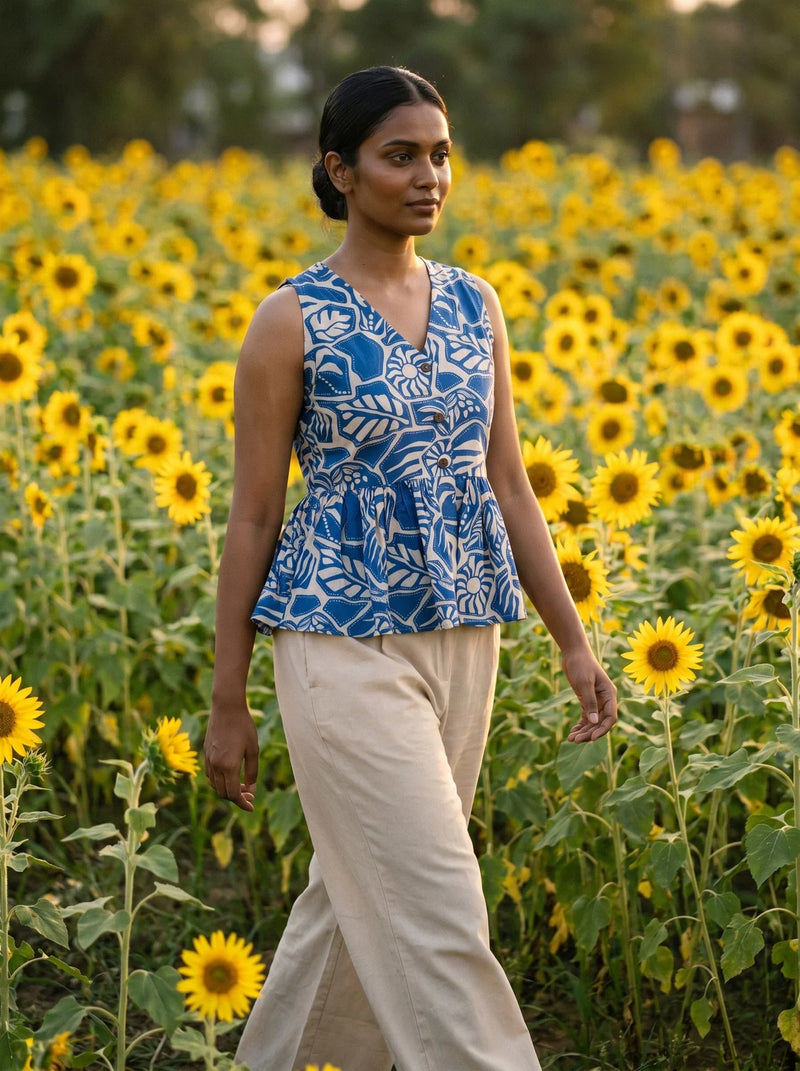 woman in royal blue botanical peplum co ord set by the pool