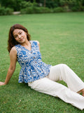 woman in royal blue botanical peplum co ord set poolside evening