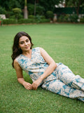 woman in teal abstract co ord set poolside evening