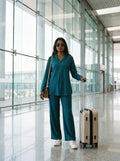 woman in teal solid viscose co ord set by a shutter